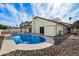 Backyard showcasing a sparkling blue in-ground swimming pool surrounded by decorative stones at 11805 N 90Th Way, Scottsdale, AZ 85260