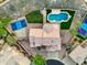 Aerial view showcasing a backyard with a sparkling pool, sports court, and well-maintained landscaping at 14049 S 8Th St, Phoenix, AZ 85048