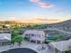 Scenic aerial view of a home with a pool and landscape nestled among hills and neighboring homes at 14049 S 8Th St, Phoenix, AZ 85048