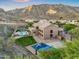 Aerial view of a luxurious backyard with pool, sports court, and lush landscaping at 14049 S 8Th St, Phoenix, AZ 85048