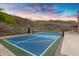 Outdoor sports court featuring basketball hoop set against desert hills and sky at 14049 S 8Th St, Phoenix, AZ 85048