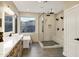 Bright bathroom featuring double vanity, soaking tub, walk-in shower, and modern fixtures at 14049 S 8Th St, Phoenix, AZ 85048