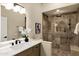Tiled bathroom with updated fixtures, a walk-in shower, and a framed decorative art piece at 14049 S 8Th St, Phoenix, AZ 85048