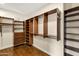 Walk-in closet with custom wood shelving and organizational features at 14049 S 8Th St, Phoenix, AZ 85048
