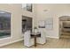 Charming dining area with a modern table, upholstered chairs, and large windows with hillside views at 14049 S 8Th St, Phoenix, AZ 85048