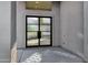 Stylish entryway featuring a textured glass and dark metal frame double door, and natural light at 14049 S 8Th St, Phoenix, AZ 85048