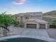 View of front yard with a three-car garage, desert landscaping, and a tile roof at 14049 S 8Th St, Phoenix, AZ 85048