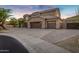 Elegant two-story home featuring a three-car garage, desert landscaping, and a tile roof at 14049 S 8Th St, Phoenix, AZ 85048