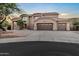 Elegant two-story home featuring a three-car garage, desert landscaping, and a tile roof at 14049 S 8Th St, Phoenix, AZ 85048