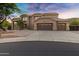 Elegant two-story home featuring a three-car garage, desert landscaping, and a tile roof at 14049 S 8Th St, Phoenix, AZ 85048