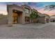 Attractive two-story home with a tile roof, arched entry, desert landscaping, and a large front door at 14049 S 8Th St, Phoenix, AZ 85048