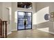 Grand foyer showcasing a decorative glass front door, high ceilings, and wood-look flooring at 14049 S 8Th St, Phoenix, AZ 85048