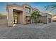 Elegant home exterior with a grand entrance, tile roof, desert landscaping, and a view of a circular driveway at 14049 S 8Th St, Phoenix, AZ 85048