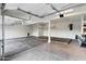 Spacious three-car garage with concrete floors and storage shelving at 14049 S 8Th St, Phoenix, AZ 85048