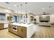 Open layout kitchen with a large island, pendant lighting, stainless steel appliances, and a view of the pool at 14049 S 8Th St, Phoenix, AZ 85048