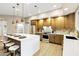 Open floor plan kitchen featuring an island with seating, stainless steel appliances, and ample storage at 14049 S 8Th St, Phoenix, AZ 85048