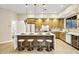 Kitchen with a large center island, custom lighting, modern stools, and plenty of cabinet space at 14049 S 8Th St, Phoenix, AZ 85048