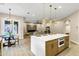 Open layout kitchen with large island, pendant lighting, stainless steel appliances, and backyard access at 14049 S 8Th St, Phoenix, AZ 85048