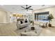 Open floor plan living room with modern sofa, comfortable chairs, and an inviting view to the backyard pool at 14049 S 8Th St, Phoenix, AZ 85048