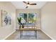 Bright home office with modern desk, neutral walls, and large windows offering a pleasant view at 14049 S 8Th St, Phoenix, AZ 85048
