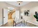 Lovely home office featuring a modern desk, decor, and an open view to the home's staircase at 14049 S 8Th St, Phoenix, AZ 85048
