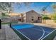 Pickleball court with sports net, with house and mountain views in background at 14049 S 8Th St, Phoenix, AZ 85048