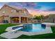 Outdoor swimming pool with diving board, grill and mountain views at dusk at 14049 S 8Th St, Phoenix, AZ 85048