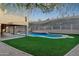 Backyard pool with waterfall feature, surrounded by manicured lawn at 14049 S 8Th St, Phoenix, AZ 85048