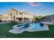 Backyard pool with diving board, surrounded by manicured lawn and the home at 14049 S 8Th St, Phoenix, AZ 85048