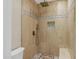 Luxurious tiled shower with a rainfall showerhead and built-in bench seating at 14049 S 8Th St, Phoenix, AZ 85048