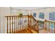 Staircase with wood railing and views of the entry and yard at 14049 S 8Th St, Phoenix, AZ 85048