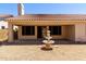 Charming backyard featuring a decorative fountain and covered patio for outdoor relaxation at 14470 N 98Th Pl, Scottsdale, AZ 85260