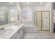 Bathroom featuring double sinks, separate shower and soaking tub, and shuttered windows at 14470 N 98Th Pl, Scottsdale, AZ 85260
