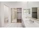 Bright bathroom features marble floors, double sinks, and a separate closet with mirrored sliding door at 14470 N 98Th Pl, Scottsdale, AZ 85260