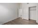 Bedroom featuring contemporary wood-look flooring and a closet with folding doors at 14470 N 98Th Pl, Scottsdale, AZ 85260