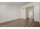 Open bedroom with plank flooring and access to an adjoining bathroom and closet at 14470 N 98Th Pl, Scottsdale, AZ 85260