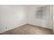 Comfortable bedroom with contemporary wood-look flooring and a window with blinds at 14470 N 98Th Pl, Scottsdale, AZ 85260