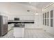 Well-lit kitchen with stainless appliances, granite countertops, and white cabinetry at 14470 N 98Th Pl, Scottsdale, AZ 85260