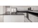 Kitchen featuring granite countertops, white cabinets, and stainless steel appliances overlooking the living room at 14470 N 98Th Pl, Scottsdale, AZ 85260