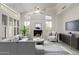 Bright living room with vaulted ceilings, large windows, a fireplace, and modern furnishings at 14470 N 98Th Pl, Scottsdale, AZ 85260