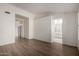 Open living area with wood floors, white walls, and access to bathroom at 14470 N 98Th Pl, Scottsdale, AZ 85260