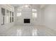 Bright living room featuring a fireplace, white marble floors, and shuttered windows at 14470 N 98Th Pl, Scottsdale, AZ 85260