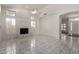 Bright living room with marble floors, fireplace, and lots of natural light through shuttered windows at 14470 N 98Th Pl, Scottsdale, AZ 85260