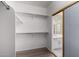 Spacious walk-in closet featuring ample shelving and sliding door access to the ensuite bathroom at 14470 N 98Th Pl, Scottsdale, AZ 85260