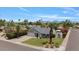 Beautiful single-story home with lush landscaping, well-maintained lawn, and clear blue skies at 16409 N 65Th Pl, Scottsdale, AZ 85254