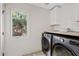 Efficient laundry room featuring modern washer/dryer and plenty of storage space at 16409 N 65Th Pl, Scottsdale, AZ 85254