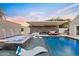 Outdoor pool and spa area featuring lounge seating and a covered patio, perfect for entertaining at 16409 N 65Th Pl, Scottsdale, AZ 85254
