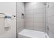 Relaxing bathroom boasts a tub, white tile walls, and modern towel rack at 1642 E Monte Vista Rd # 10, Phoenix, AZ 85006
