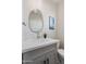 Chic powder room features a modern vanity with sleek gray cabinetry and abstract mirror at 1642 E Monte Vista Rd # 10, Phoenix, AZ 85006