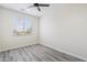 Bright bedroom with light gray wood-look flooring and large window at 1642 E Monte Vista Rd # 10, Phoenix, AZ 85006